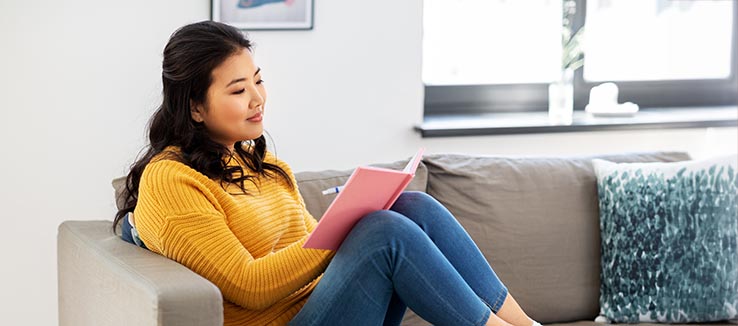 woman tracking exercise and mood in diet journal