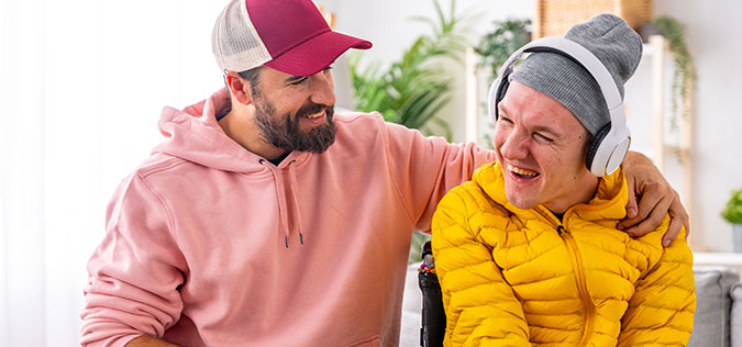 Smiling disabled man and caregiver dad