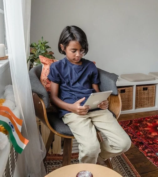 PrasadCounselingAndTraining-child-on-tablet Child on tablet.