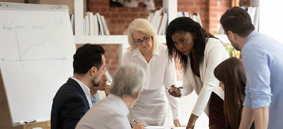 Black woman focused employee talking to cowokers in office brainstorm discussing startup plan project at meeting, navigating stereotypes and microaggressions