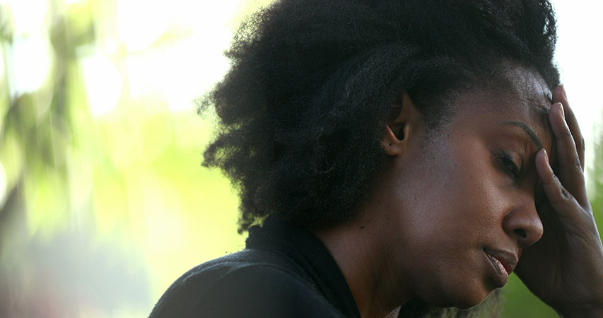 tired black woman looking stressed from stereotypes