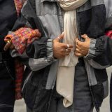 3 women in scarves linking arms
