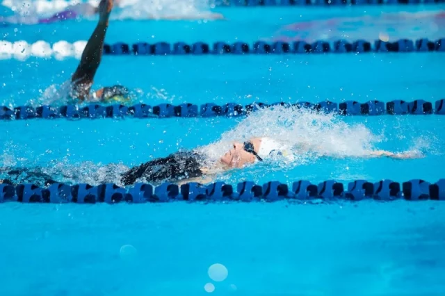 A woman swimming laps in a pool.