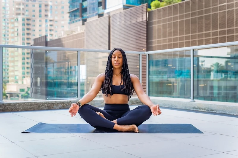 A woman meditating.