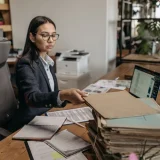 A business woman working at a desk.