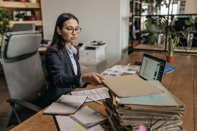 A business woman working at a desk.